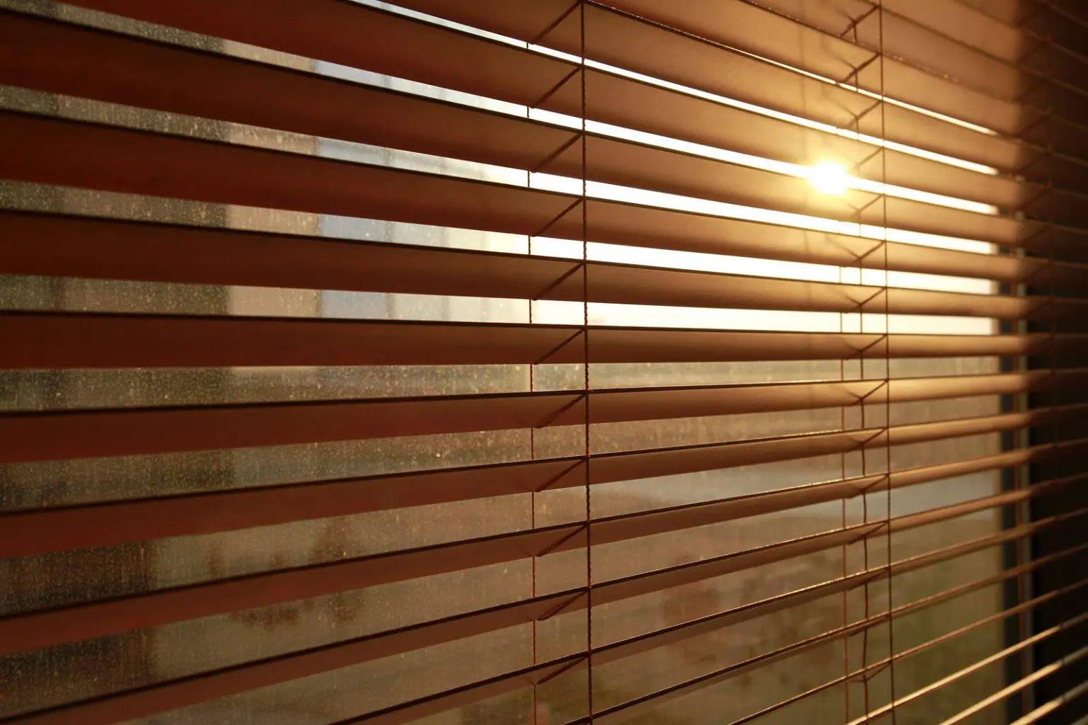 Sunlight streaming through custom window blinds in a Southern California home